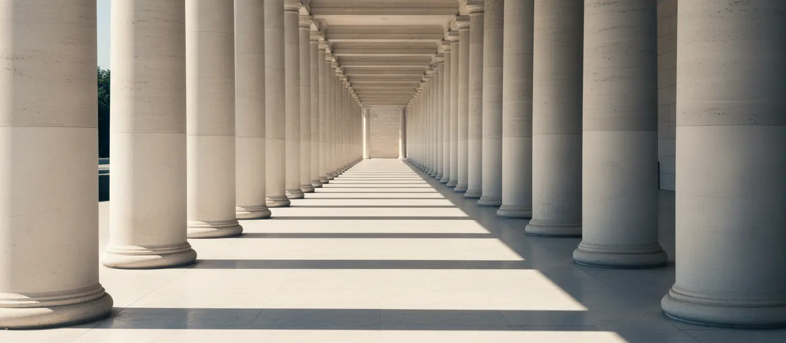 A stone colonnade of repeating columns