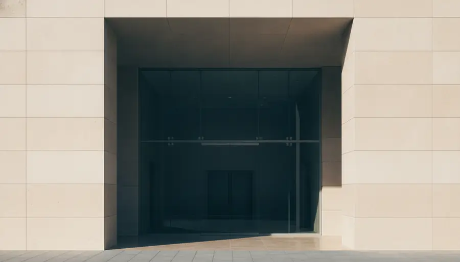 The entrance of a modern stone and glass building